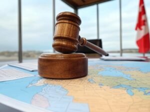 A table with legal documents, a gavel, and a copy of the Canadian Constitution (represented by a book with the title "Constitution Act, 1867" on the spine). On the table, there’s also a map of Canada highlighting the provinces, symbolizing provincial authority